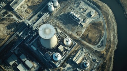 A clean, high-resolution aerial view of a nuclear power plant with cooling towers, reactors, and a network of roads, emphasizing its scale and structure