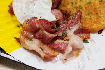 A Delicious and Satisfying Breakfast Platter featuring Bacon and Egg for your delight