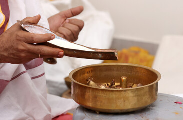Performing Pooja for Hindu god siva linga with milk, honey and coconut water	
