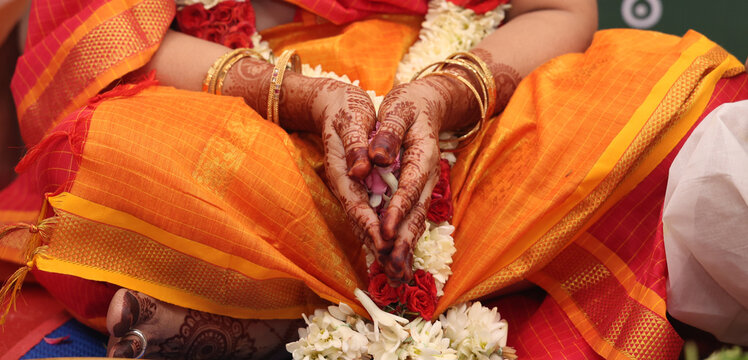 a mami , brahmin woman in mehendhi hands praying 