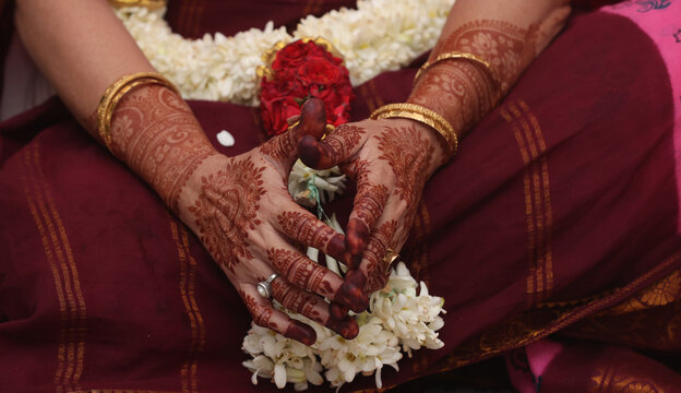 a mami in mehendhi hands praying 