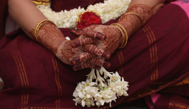 a mami in mehendhi hands praying 