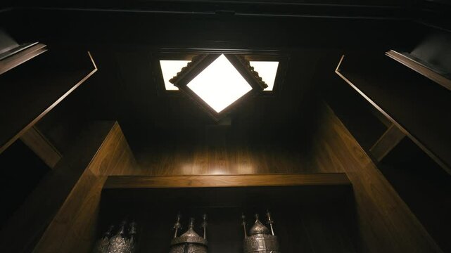 Illuminated Torah Scrolls Displayed in Wooden Aron Kodesh in Synagogue