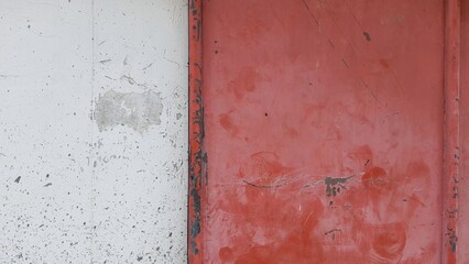 Metal rust door background, red metal rust texture with old cement wall. Old red iron gate and antique grey wall.