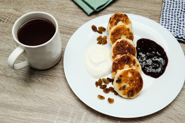 Cheesecake with jam placed on plate. Concept of a sweet dessert, teatime, and homemade baking.