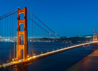 Night time long exposure of Golden Gate bridge with city skyline in the background