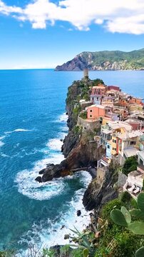 Experience the breathtaking views of colorful houses perched on cliffs overlooking the azure sea. This charming village in Vernazza Italy in Cinque Terre