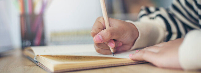 Planner or organizer writing daily appointment On Calendar book. Asian woman hand plan business timetable meeting agenda and note schedule business in diary. Planner concept-banner image.