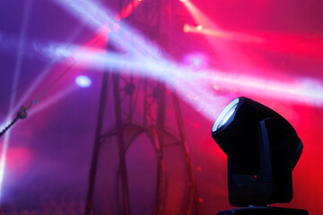 Concert equipment with multi colored spotlights. Rays of light on the circus arena. Metal supports.