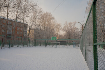 the yard stadium is noticeable with snow.winter in the city.snowdrifts in the city.cars under the snow.