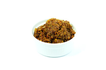 Thai red chili paste in a white cup isolated on white background closed up. An ingredient of Thai curry and Thai stir-fried vegetable, versatile paste in Thai cuisine.