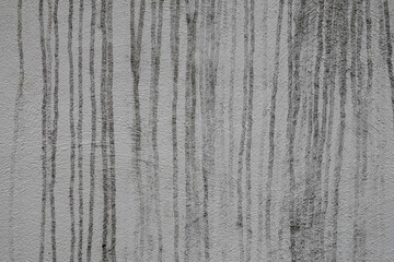 Coulures et dégoulines sales sur un mur crépi blanc