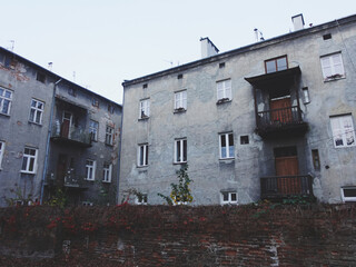 A timeworn apartment building with balconies and cracked walls, highlighting the charm of urban...