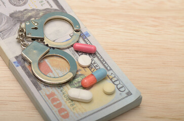 Crime and Justice Concept: Banknotes, Handcuffs, and Drugs Representing Illegal Activities and Law Enforcement Themes