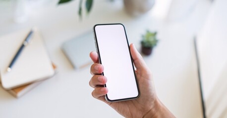 Mockup Hand Holding Smartphone: A hand holds a smartphone with a blank screen, perfect for showcasing your app or website design.