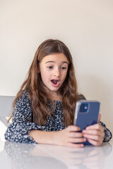 Fototapeta premium Surprised girl with a phone. Technology concept.