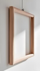 Blank wooden frame hanging on the white wall
