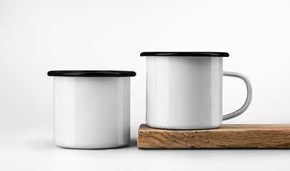 Template of two white metal mugs with black rim, on edge of old wood board, iron cups on textured wood, isolated on background.