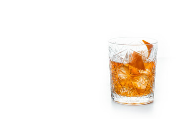 Old fashioned cocktail garnished with orange isolated on white background. Copy space