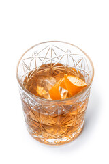 Old fashioned cocktail garnished with orange isolated on white background