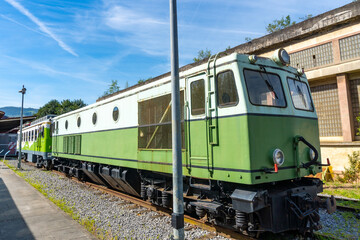 Fototapeta premium A green train is parked on the tracks