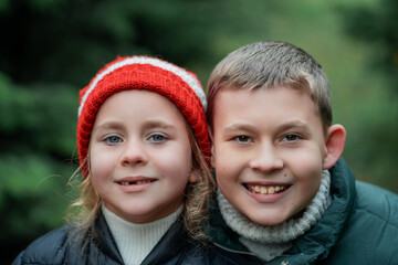 Cute little children choose Christmas tree for home at the market. Winter holidays.