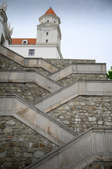 Stone serpentine steps leading up to buiding with tower