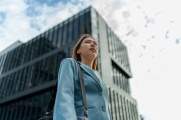 Portrait of a young and confident businesswoman standing in front a modern office building in the financial district