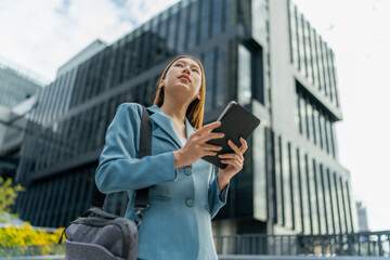 Fototapeta premium Young Asian Businesswoman Using Digital Tablet While On The Way To The Office In The Morning