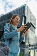 Fototapeta premium Young Asian Businesswoman Using Digital Tablet While On The Way To The Office In The Morning