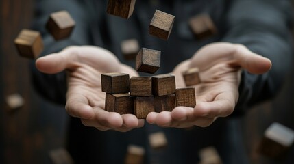 A young man cradles wooden cubes in his hands, symbolizing care and protection for family members.
