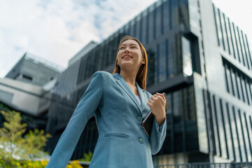 Fototapeta premium Young Businesswoman Using Digital Tablet In Front A Modern Office Building in a Financial District