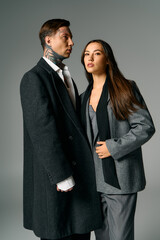 A young couple showcases trendy outfits, exuding confidence and modern charm together.