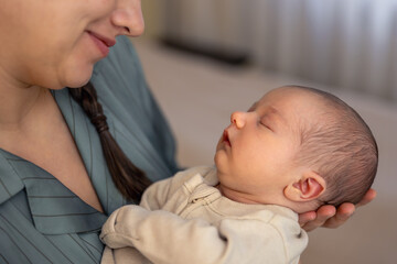 A young mother with a newborn baby. Newborn baby.