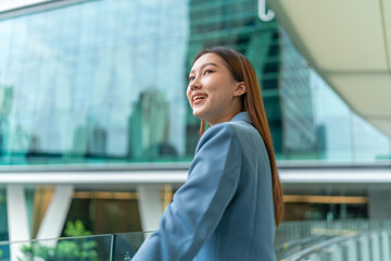 Portrait of a young and confident businesswoman standing in front a modern office building in the financial district