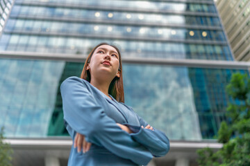 Portrait of a young and confident businesswoman standing in front a modern office building in a financial district