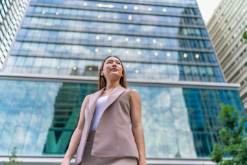 Portrait of a young and confident businesswoman standing in front a modern office building in the financial district