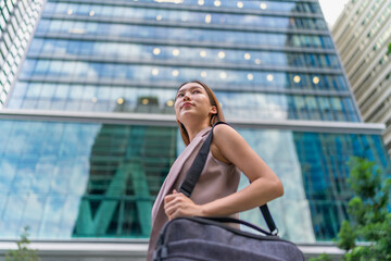 Portrait of a young and confident businesswoman standing in front a modern office building in the financial district