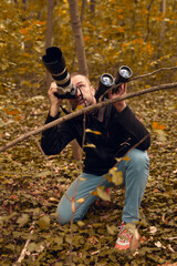 Man using binoculars and camera for birdwatching and other observable animals in nature.