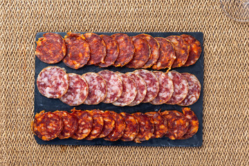A beautifully arranged charcuterie board featuring a selection of cured meats, sliced cheese, and...