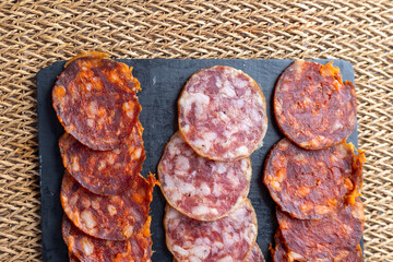 A beautifully arranged charcuterie board featuring a selection of cured meats, sliced cheese, and...