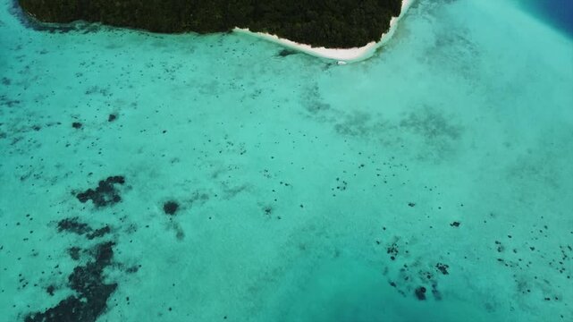 Drone flying over reef, clear blue ocean and beautiful islands in Palau 