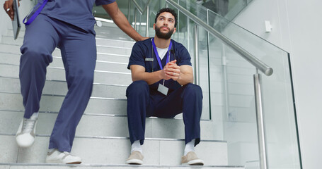 Support, man and doctors at hospital with burnout, stress or thinking on stairs together at clinic....