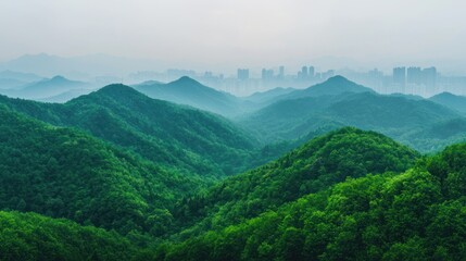 Fototapeta premium Lush green hills fade into misty mountains, with a city skyline barely visible in the background, creating a serene nature-urban contrast.