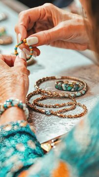 Jewelry artisan creating handmade bracelets with colorful threads and beads