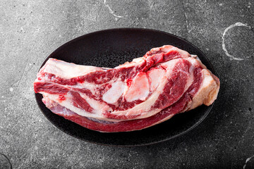 Fresh raw beef brisket, raw meat in the grey background before cooking top view