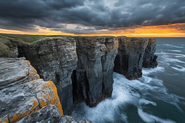 Dramatic coastal cliffs and rock formations beneath a cloudy sunset sky in captivating photography