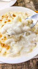 Top view of a bowl of mac and cheese served in a round bowl 