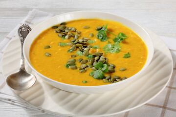 Pumpkin Red Lentil Soup in white bowl, top view