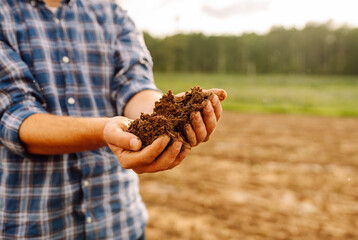 Expert farmer checking soil health before growth a seed or plant seedling. Nature healthy food.